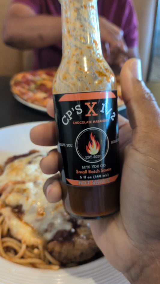 Chicken Parmesan served with CP’s X ½ Chocolate Habanero Hot Sauce